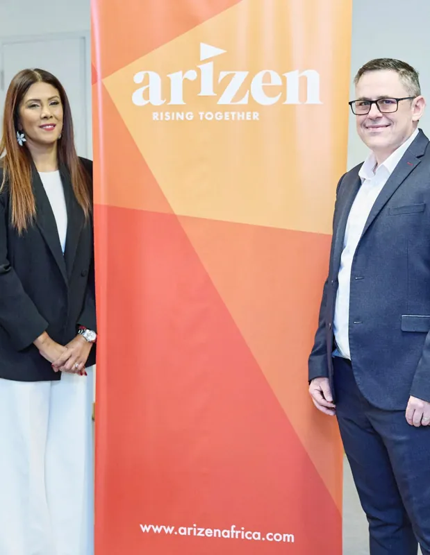 Two members of the Arizen team beside the Arizen Rising Together banner